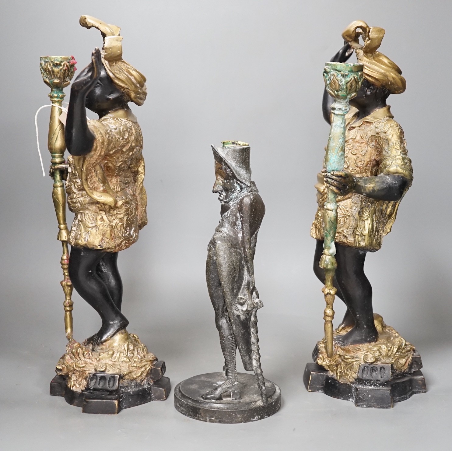 A pair of bronze blackamoor candlesticks and one other spelter figural candlestick, tallest 39cm